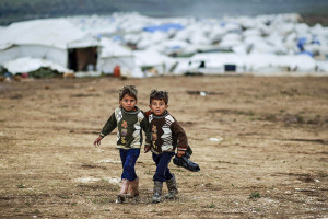 Syrian boys , whose family fled their home in Idlib, walk to their tent, at a camp for displaced Syrians. https://www.flickr.com/photos/syriafreedom/8309708775